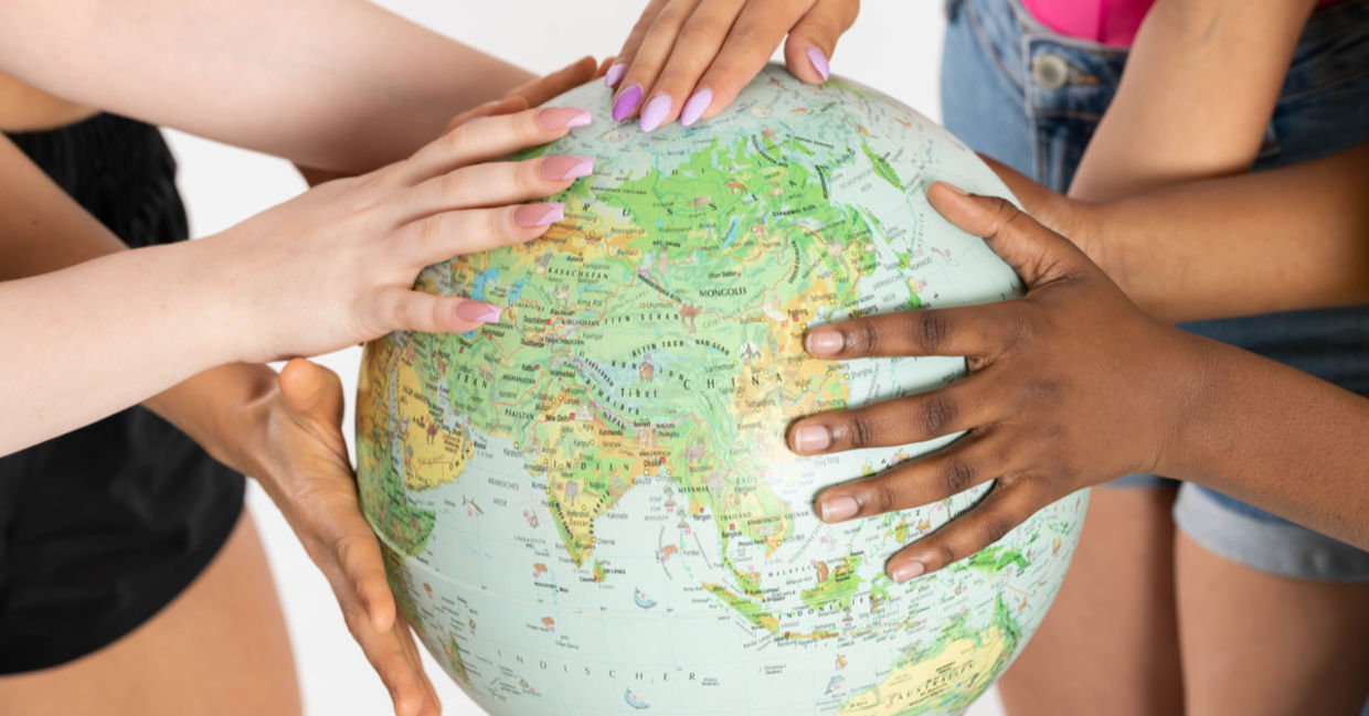 Acceptance and tolerance is depicted with multi-racial women embracing a globe. Acceptance and tolerance is depicted with multi-racial women embracing a globe.