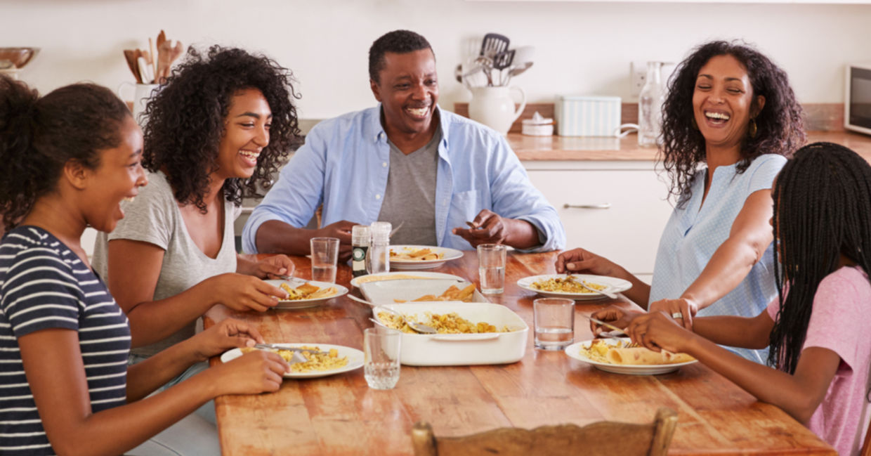 A family eating together promotes health benefits. A family eating together promotes health benefits.