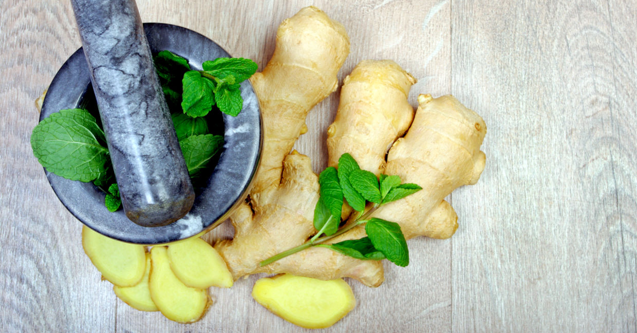Whole and sliced ginger with mint leaves Whole and sliced ginger with mint leaves