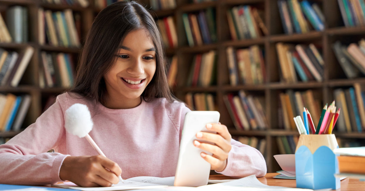 Girl using app for school work. Girl using app for school work.