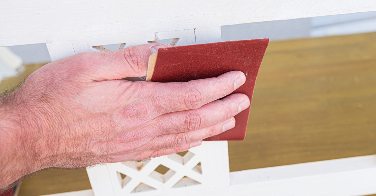 Man sanding a piece of furniture. Man sanding a piece of furniture.