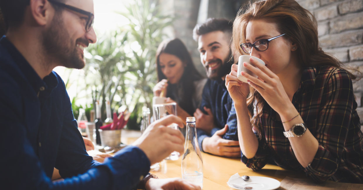 Friends sipping coffee and chatting after a meal. Friends sipping coffee and chatting after a meal.