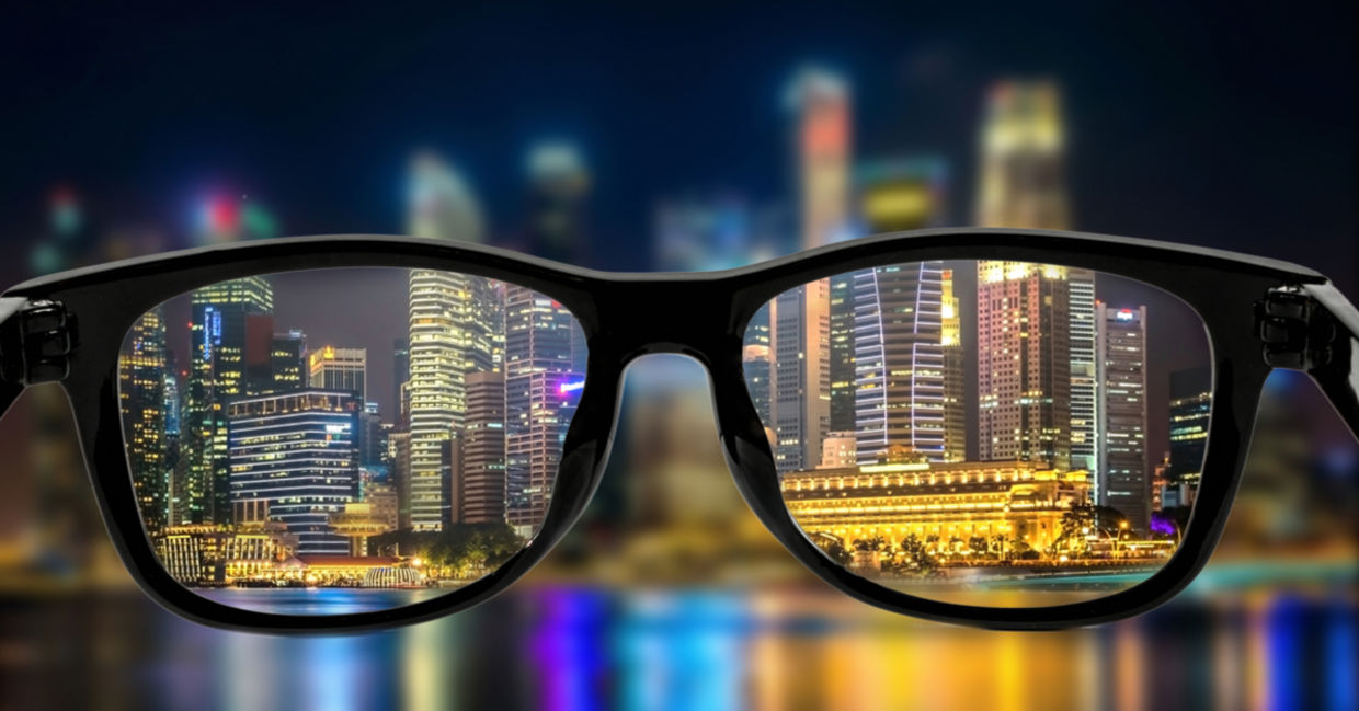 Looking through the lenses of glasses and seeing a bright cityscape at night. Looking through the lenses of glasses and seeing a bright cityscape at night.