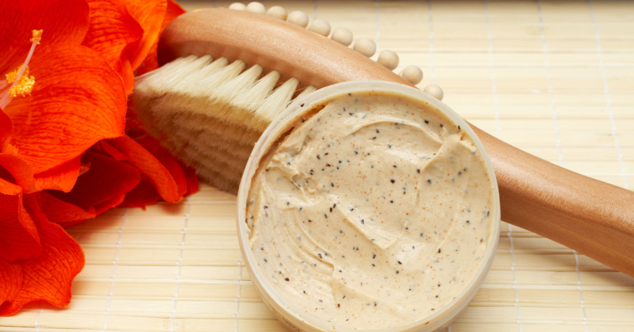 Exfoliating scrub beside a brush massager. Exfoliating scrub beside a brush massager.