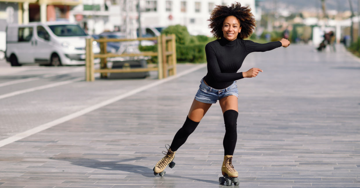 Young woman on roller skates riding outdoors in urban street Young woman on roller skates riding outdoors in urban street