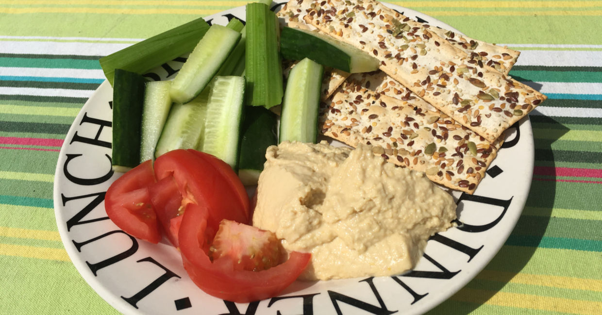 Healthy plate of hummus, crackers and sliced vegetables. Healthy plate of hummus, crackers and sliced vegetables.