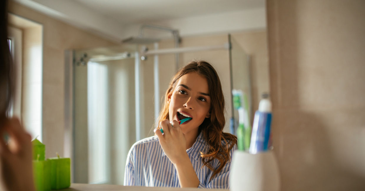 Young woman brushing her teeth Young woman brushing her teeth