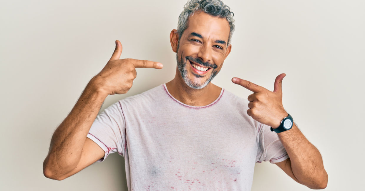 Middle aged man cheerfully showing his whiter teeth Middle aged man cheerfully showing his whiter teeth