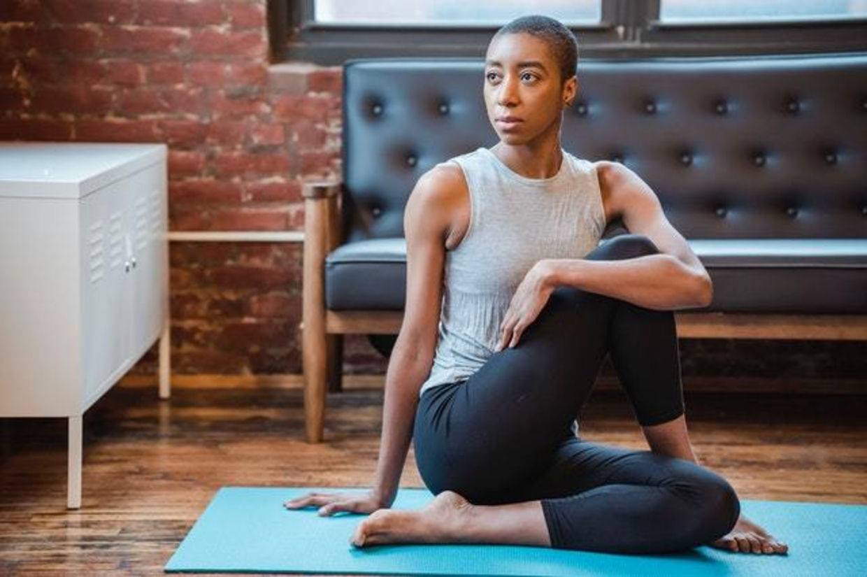 Woman doing the kemetic yoga  pose of Isis.
