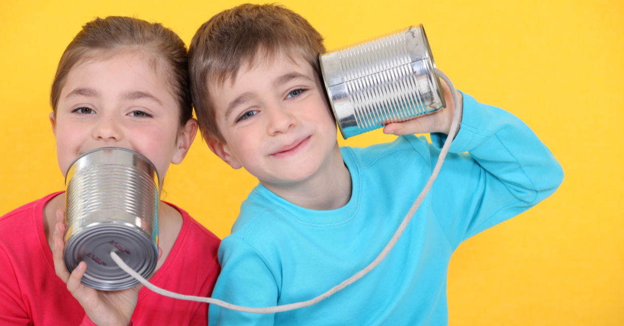 Kids having a phone call with tin cans Kids having a phone call with tin cans