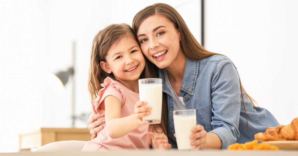 a mother and daughter enjoying vegan milk. a mother and daughter enjoying vegan milk.
