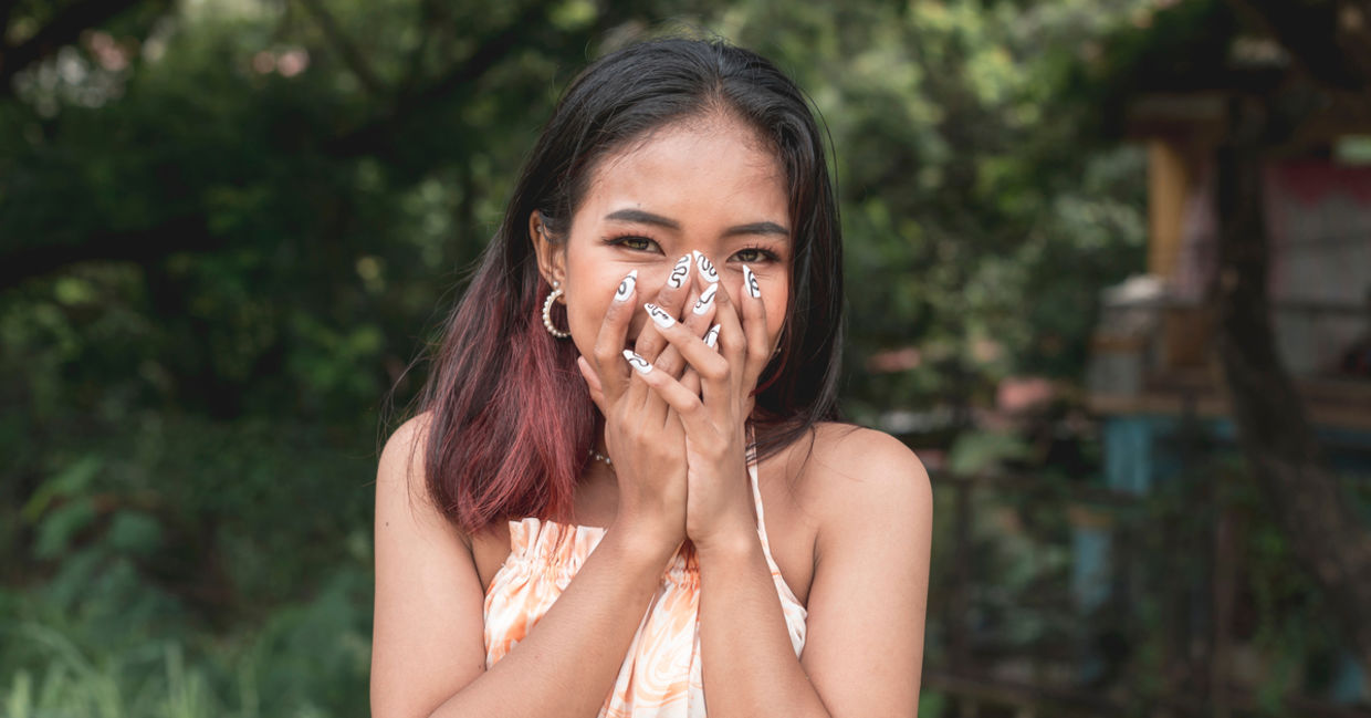 A young woman blushing. A young woman blushing.