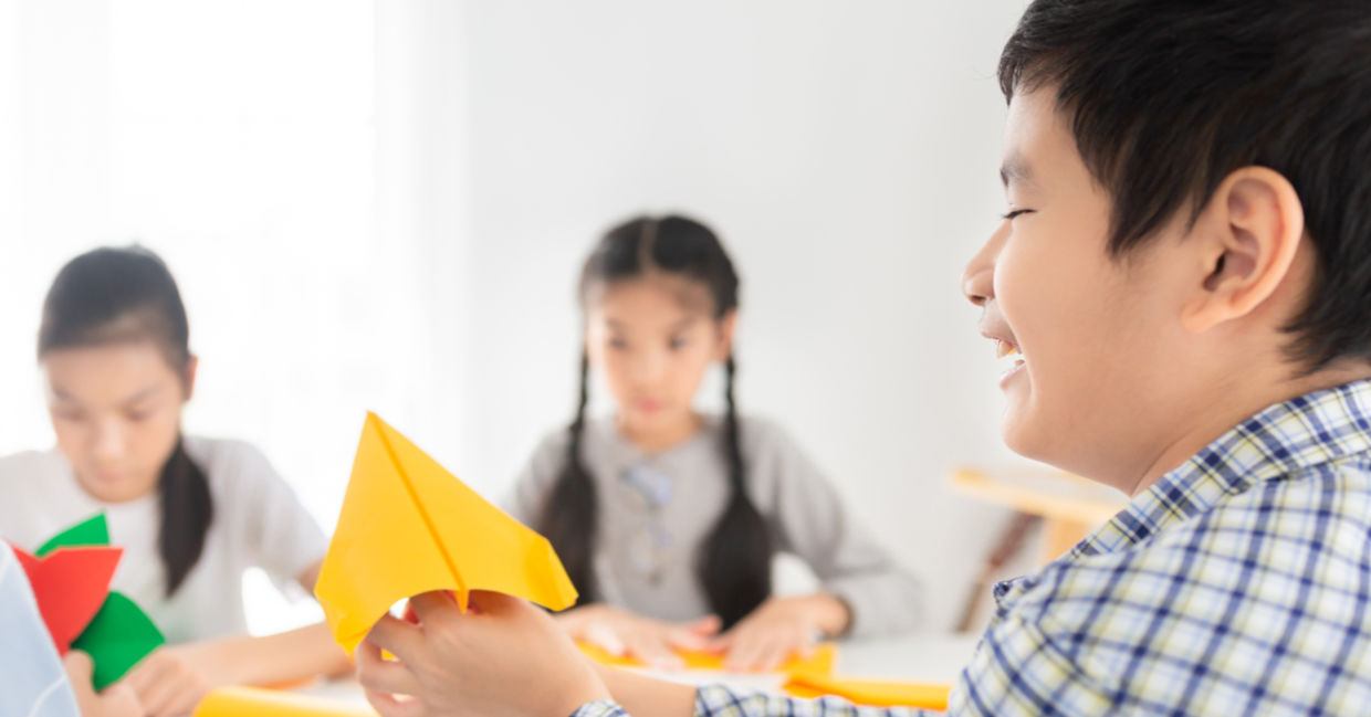 Children developing confidence and creativity by doing origami at school. Children developing confidence and creativity by doing origami at school.