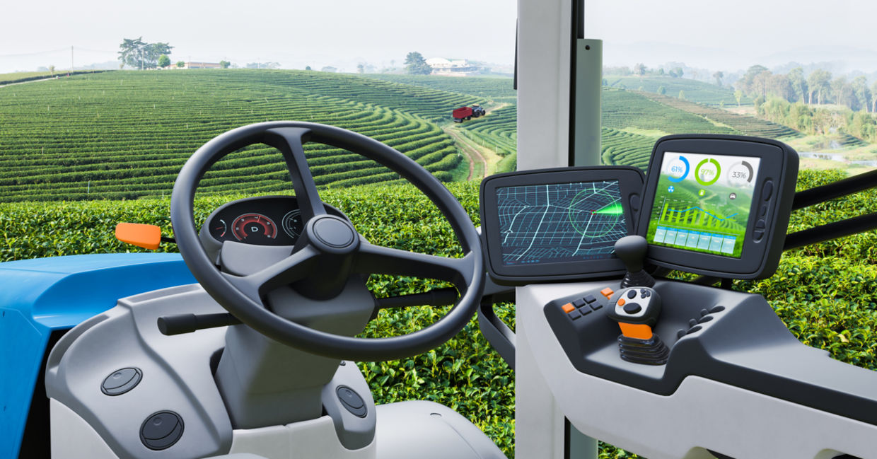 Autonomous tractor working in a green tea field. Autonomous tractor working in a green tea field.