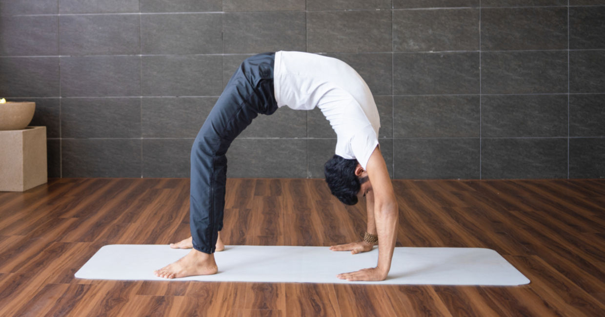 Man practicing the wheel yoga pose. Man practicing the wheel yoga pose.