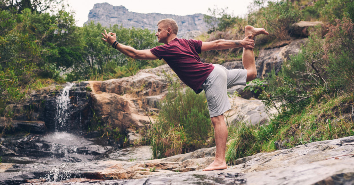 Man performing the dancers yoga pose. Man performing the dancers yoga pose.