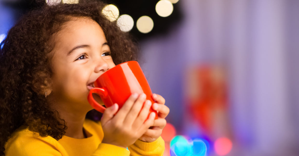 Young girl staying warm by drinking a hot cocoa. Young girl staying warm by drinking a hot cocoa.