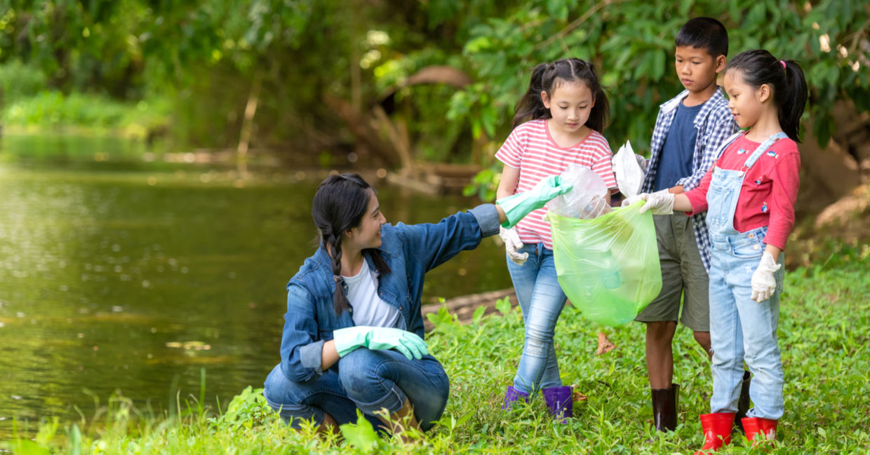 Family cleaning a park on Giving Tuesday. Family cleaning a park on Giving Tuesday.