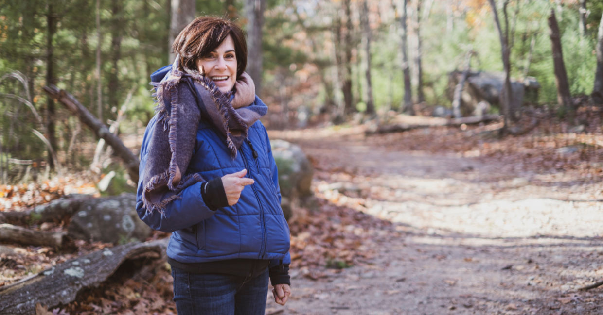 Woman staying active on a winter hike in the woods Woman staying active on a winter hike in the woods