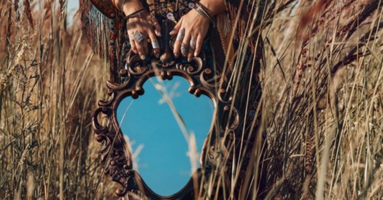 A heyoka empath is holding a mirror as she reflects the truth of others to the world. A heyoka empath is holding a mirror as she reflects the truth of others to the world.