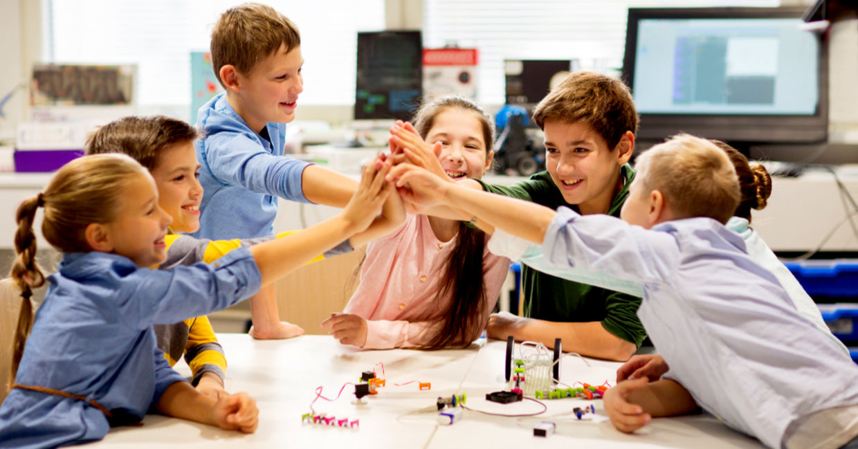 Happy children learning about tech at school Happy children learning about tech at school