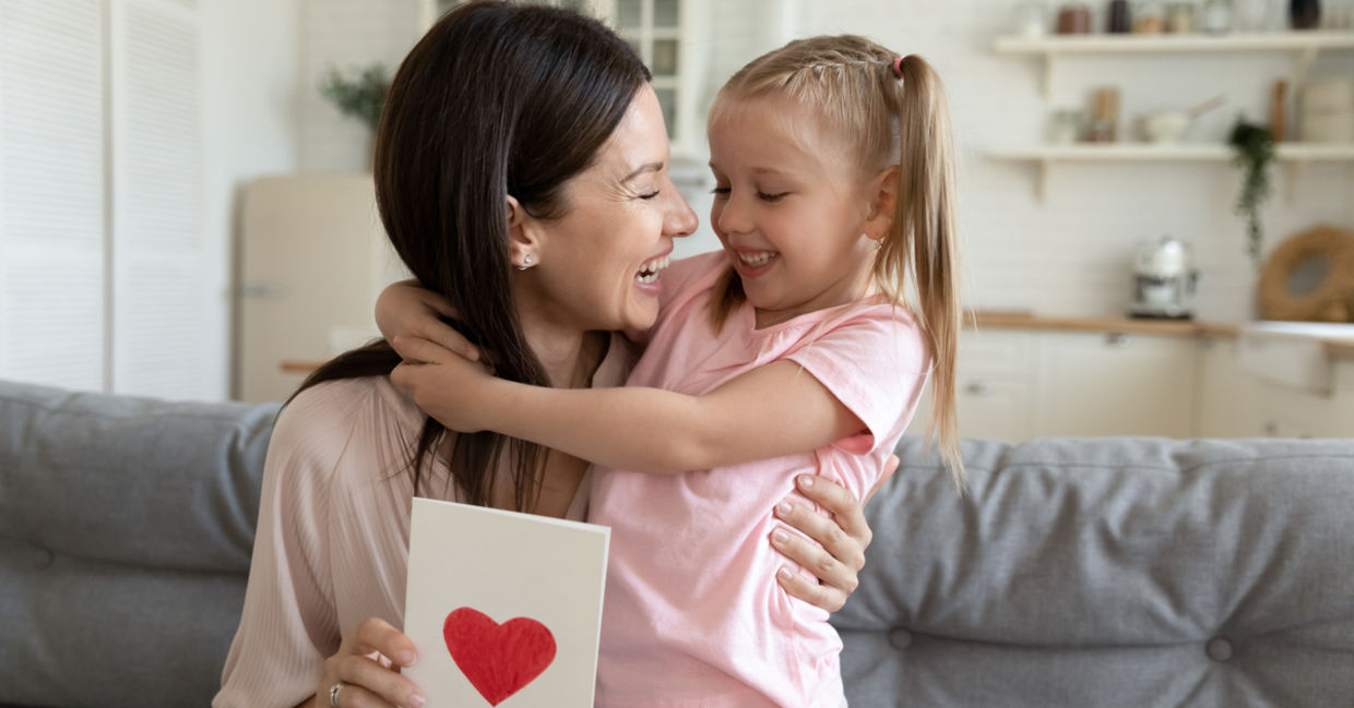 Cheerful mother and daughter hugging each other Cheerful mother and daughter hugging each other