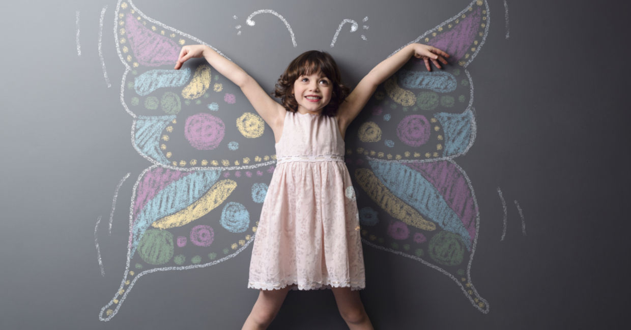 Little girl with a chalked butterfly behind her, a symbol of positive change and creativity. Little girl with a chalked butterfly behind her, a symbol of positive change and creativity.