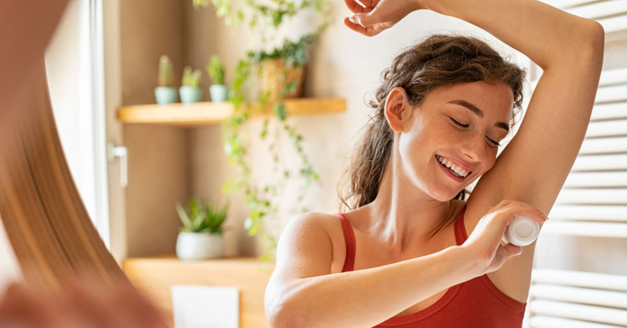 Woman using natural deodorant with tea tree oil. Woman using natural deodorant with tea tree oil.