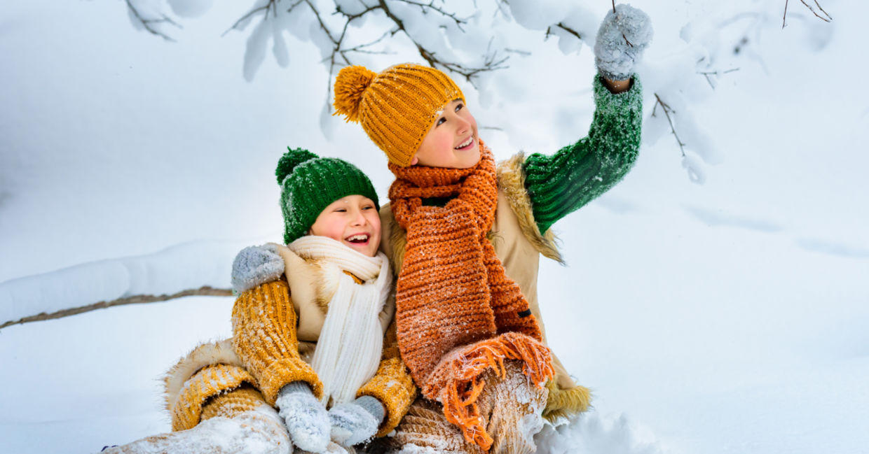 Two young girls happily play in the snow. Two young girls happily play in the snow.
