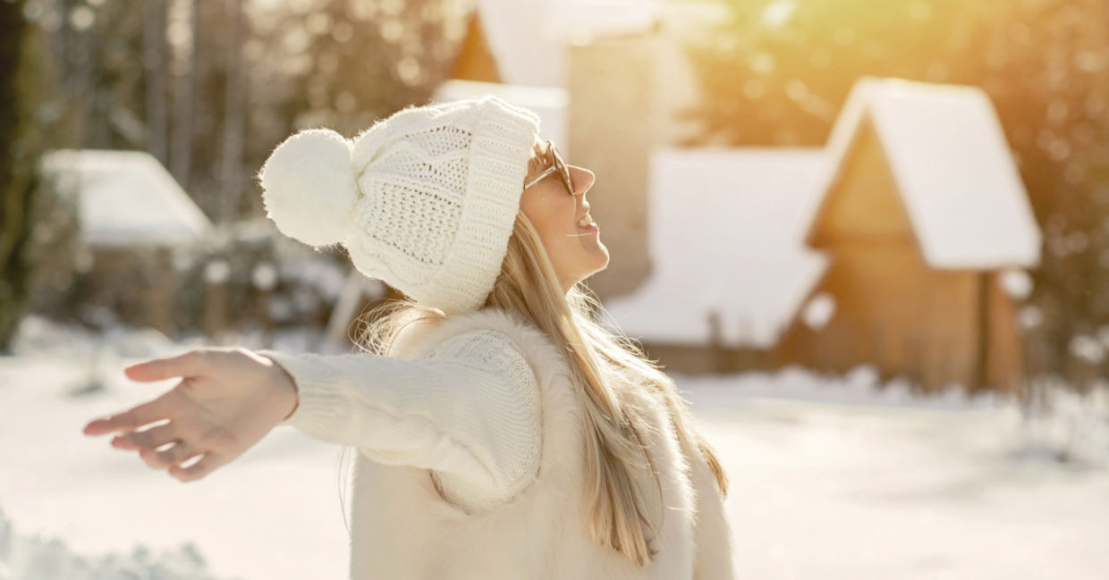 A woman enjoys a moment in the warm winter sun. A woman enjoys a moment in the warm winter sun.