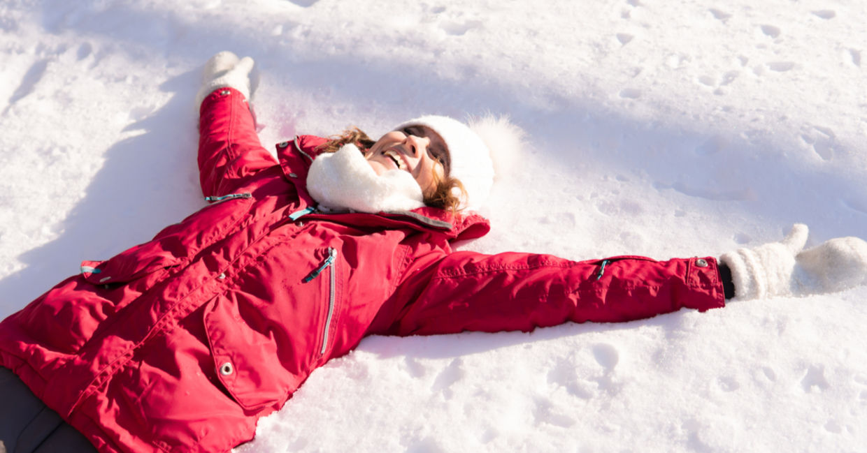 A woman lies in the snow, her body forming a sitzmark. A woman lies in the snow, her body forming a sitzmark.