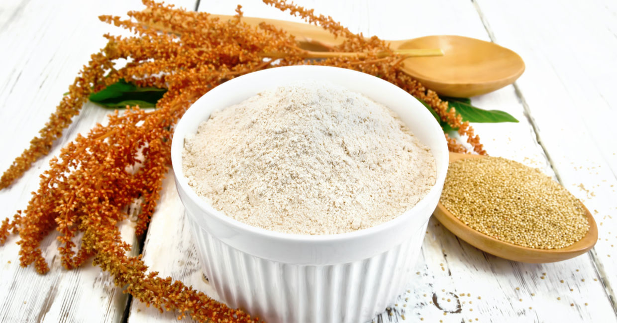 Whole amaranth seeds and ground gluten-free amaranth flour beside a sprig of amaranth. Whole amaranth seeds and ground gluten-free amaranth flour beside a sprig of amaranth.