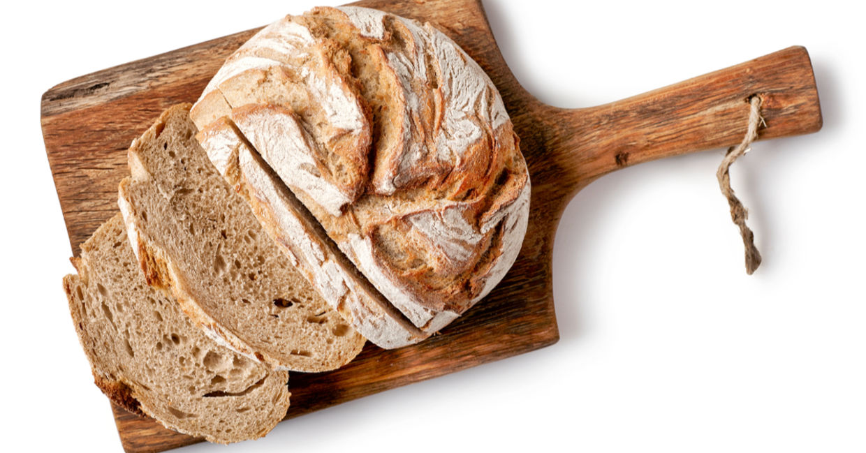 A partially sliced loaf of bread. A partially sliced loaf of bread.
