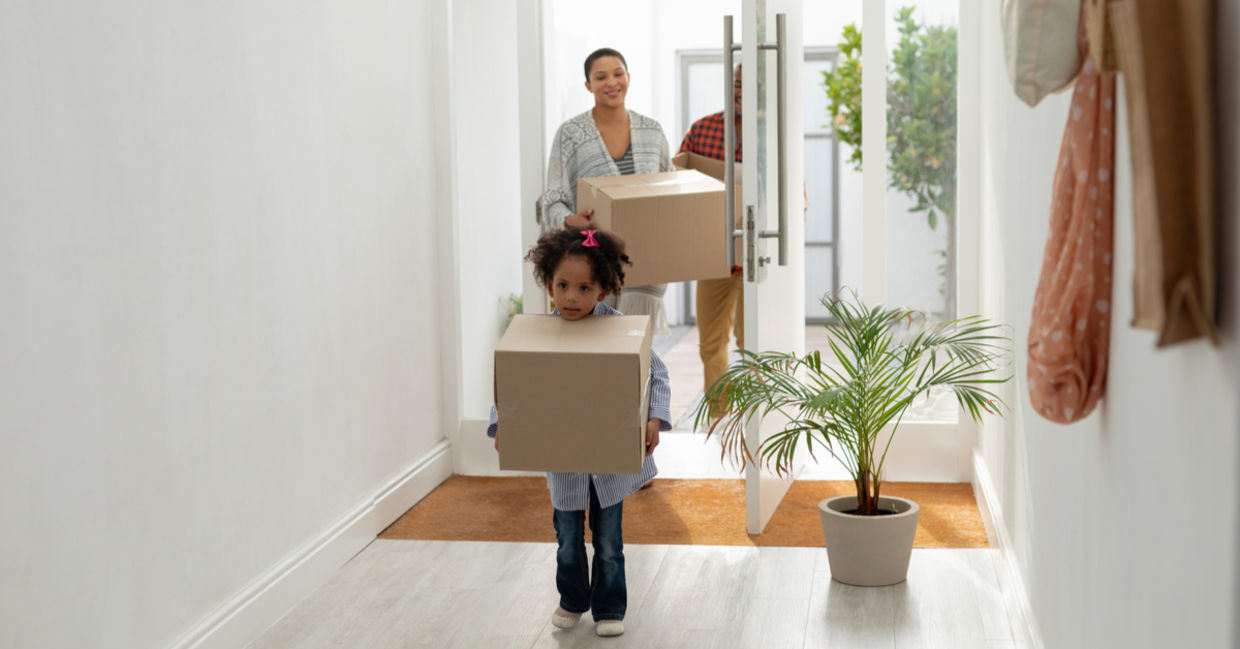 Front view of happy family entering their new home. Front view of happy family entering their new home.
