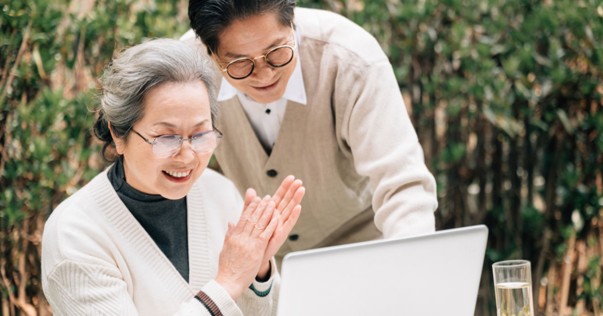 Senior couple using a laptop to code Senior couple using a laptop to code