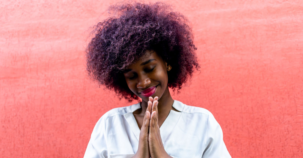 A young woman making a gesture of gratitude A young woman making a gesture of gratitude
