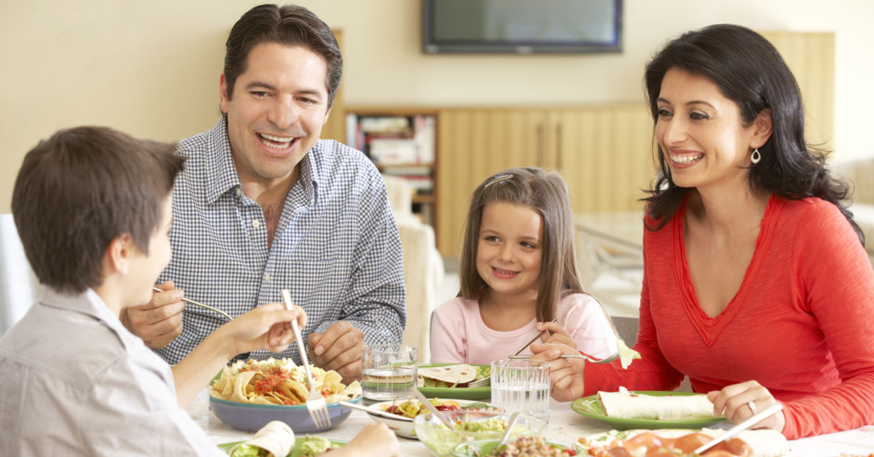 Young family enjoying a meal at home. Young family enjoying a meal at home.