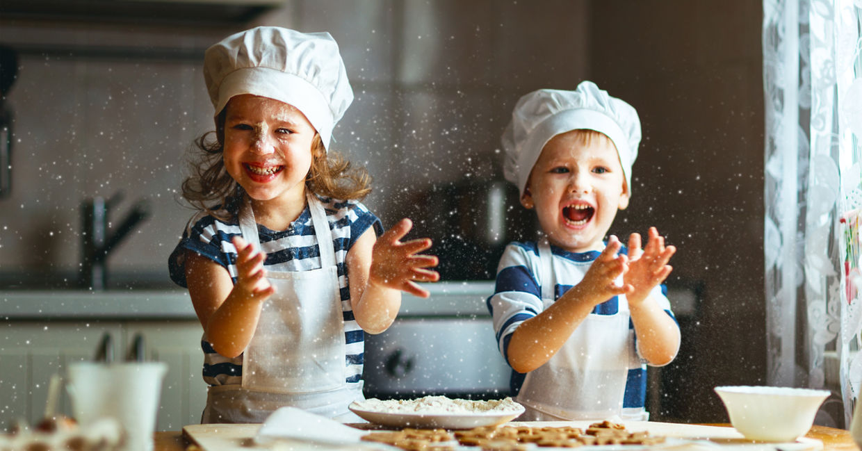 Happy kids enjoying baking cookies in their home kitchen. Happy kids enjoying baking cookies in their home kitchen.