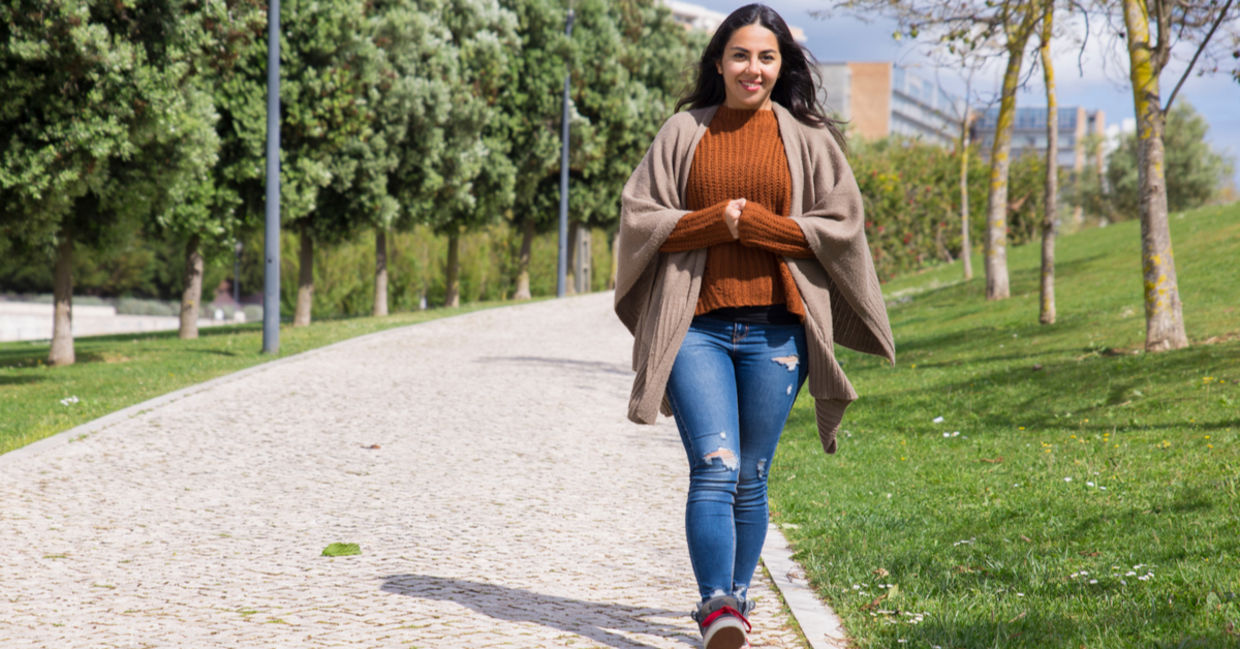 Smiling young woman taking a walk in the park. Smiling young woman taking a walk in the park.