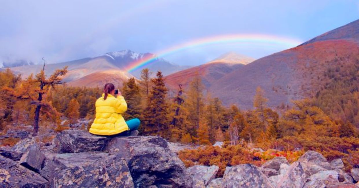 Finding courage while seated in nature admiring a rainbow. Finding courage while seated in nature admiring a rainbow.