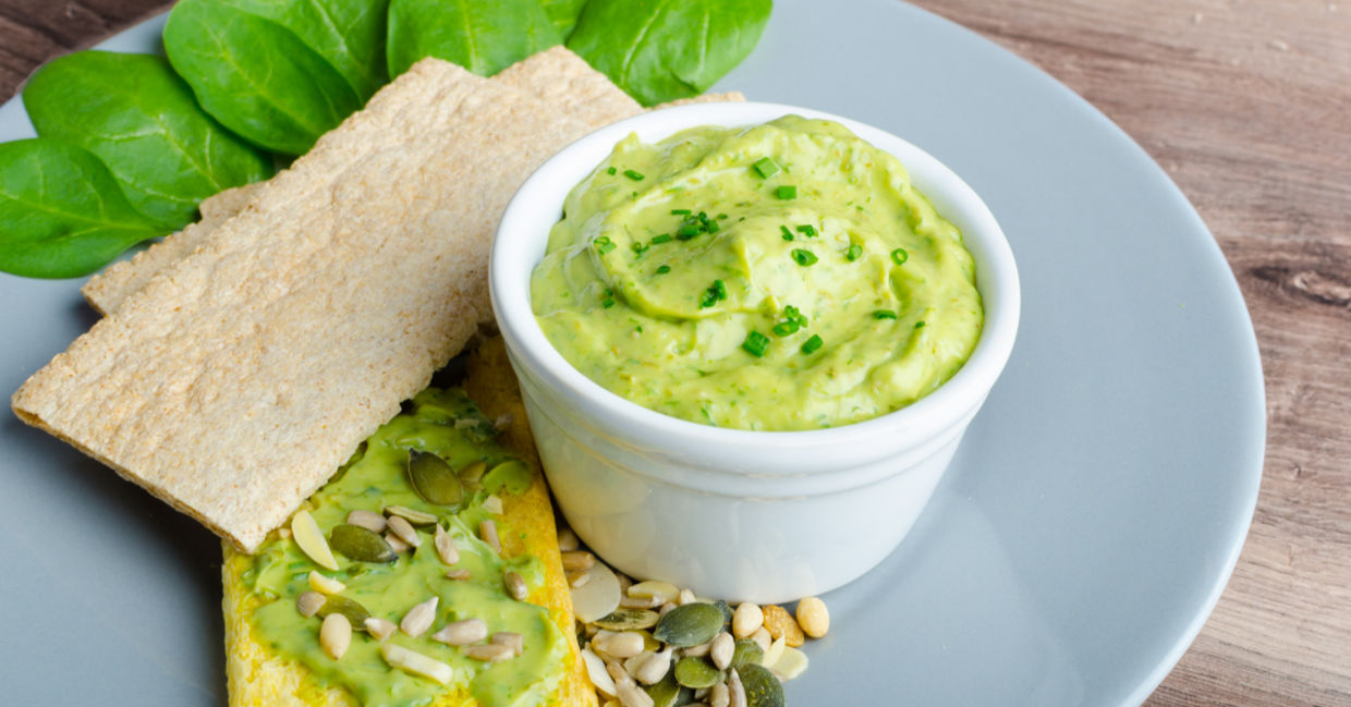 Vegan green goddess dip served with crackers. Vegan green goddess dip served with crackers.