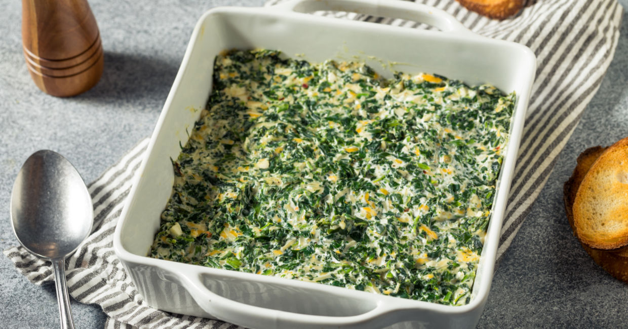 Creamy baked spinach dip in a casserole dish. Creamy baked spinach dip in a casserole dish.