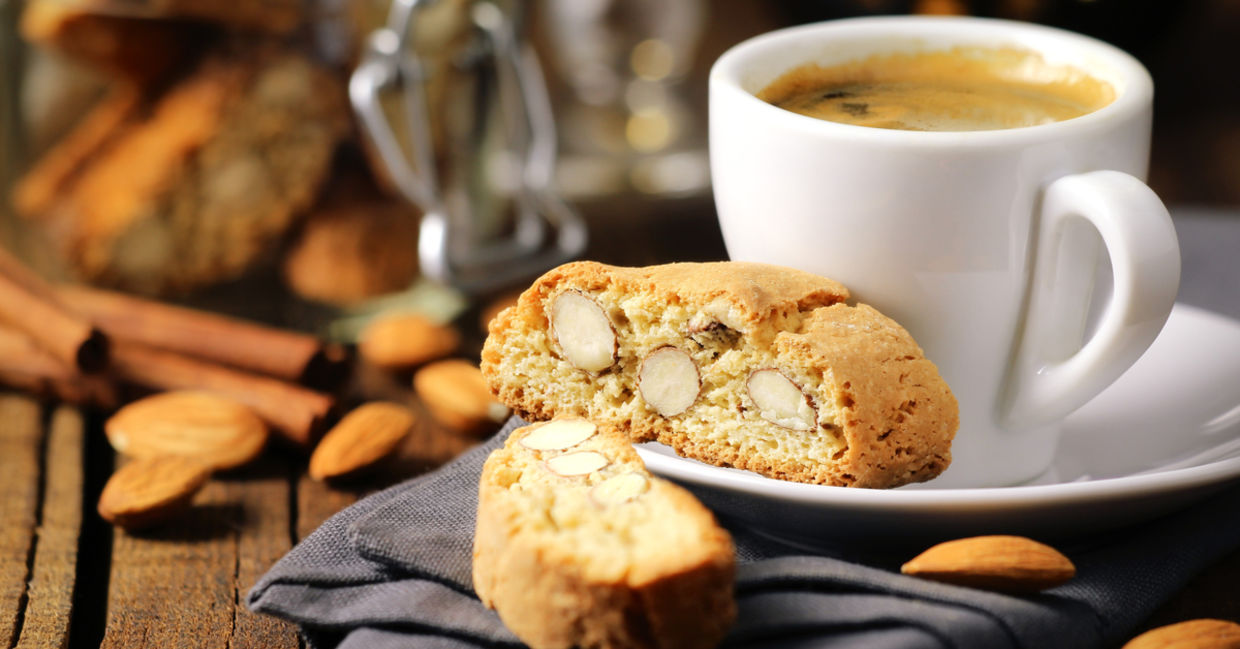 Frothy Italian espresso coffee with Italian almond biscuits. Frothy Italian espresso coffee with Italian almond biscuits.
