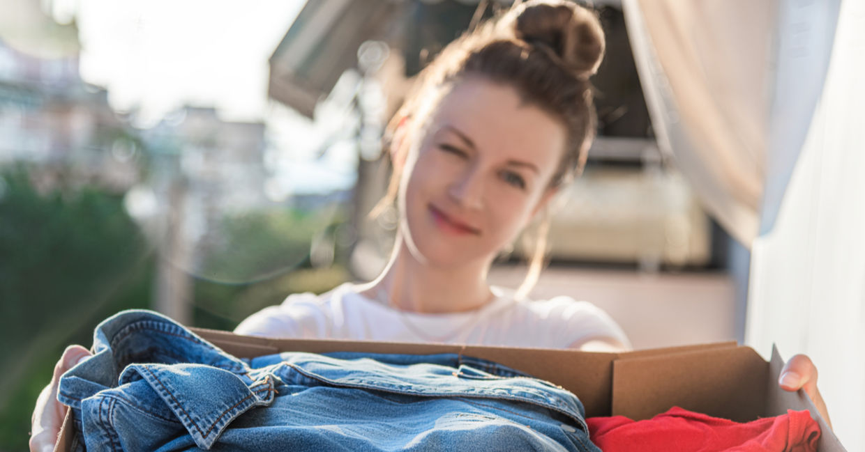 Young woman donating preloved clothing. Young woman donating preloved clothing.