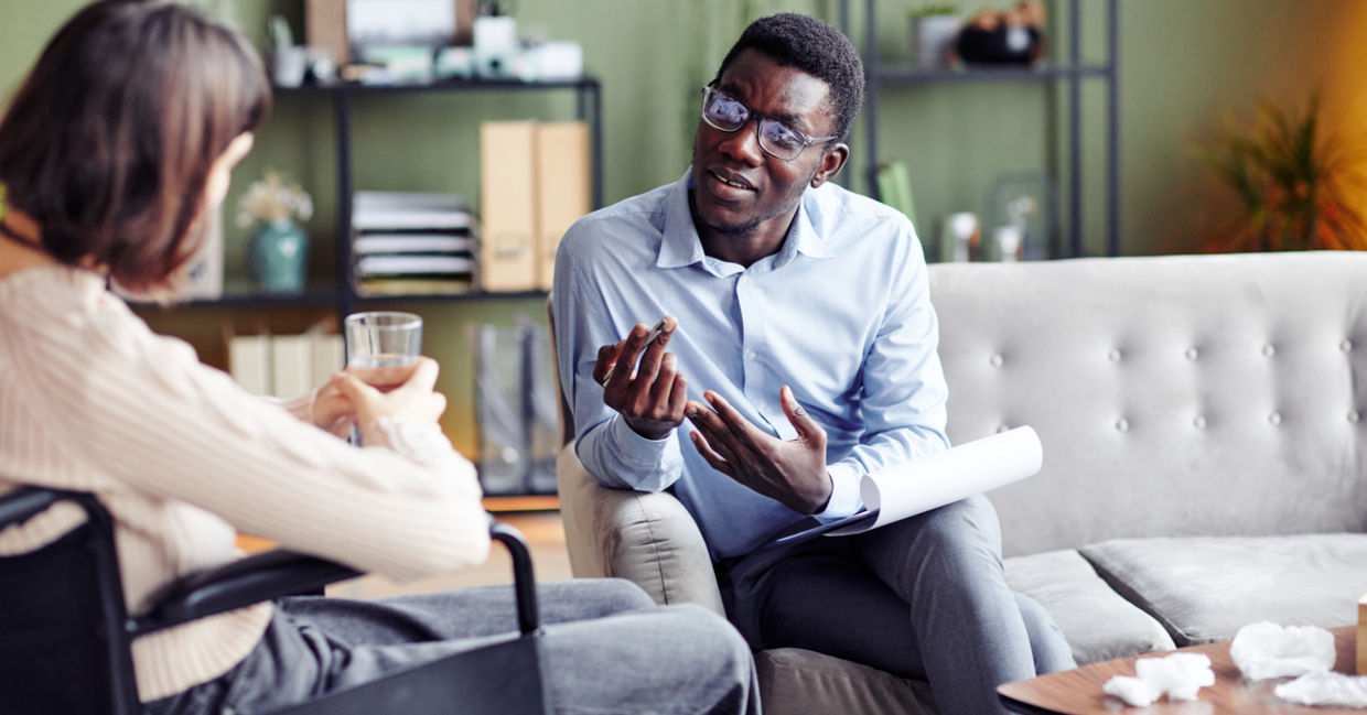 Psychologist teaching young woman stress management and other coping skills. Psychologist teaching young woman stress management and other coping skills.
