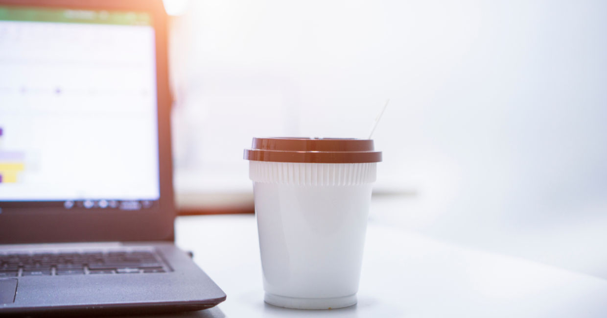 Hot espresso on the desk by a laptop computer to help with focus. Hot espresso on the desk by a laptop computer to help with focus.