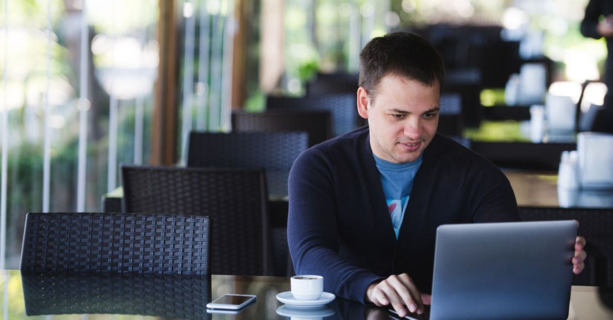 Concentrated male student studying with a laptop and drinking espresso. Concentrated male student studying with a laptop and drinking espresso.
