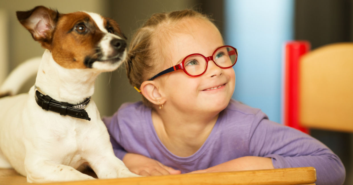 Cute girl learning with the help of a friendly dog. Cute girl learning with the help of a friendly dog.