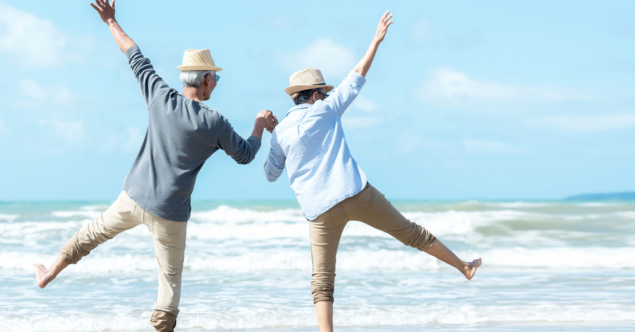 Seniors having fun during a beach walk. Seniors having fun during a beach walk.