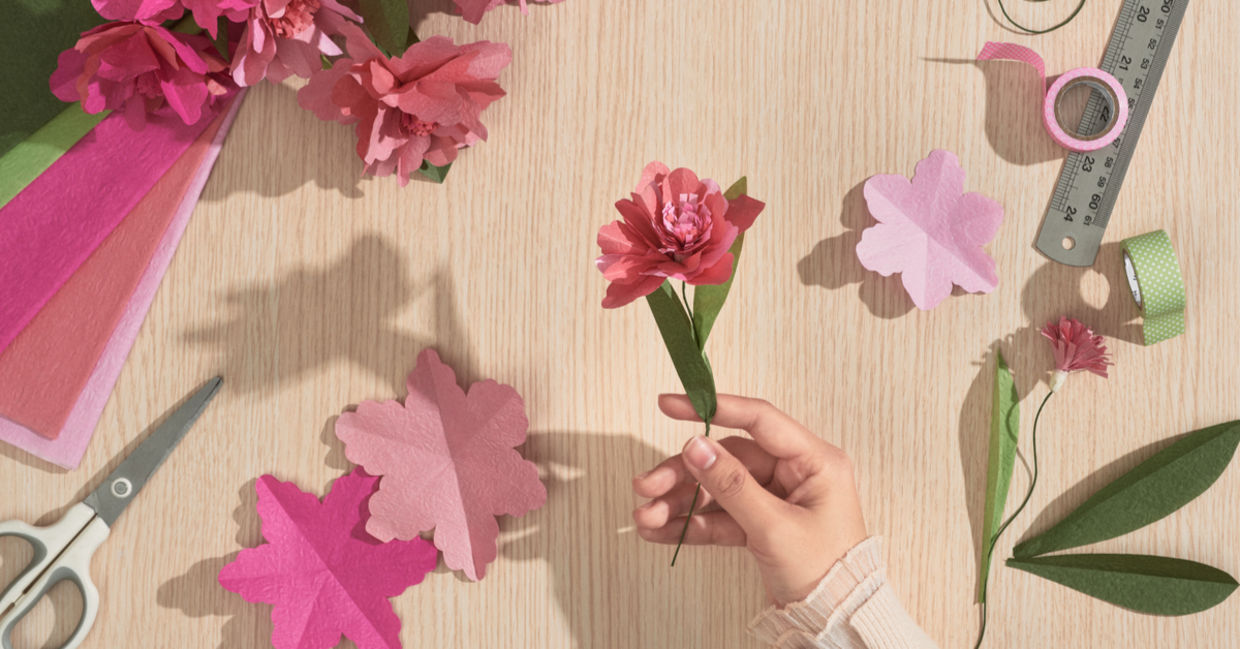 A girl holding a paper flower. A girl holding a paper flower.